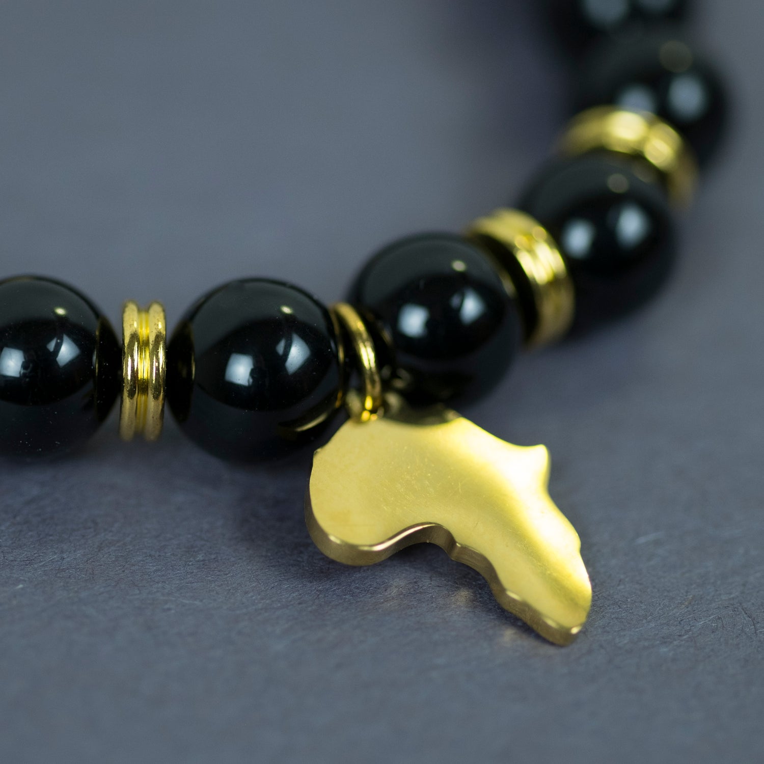 Black "One Africa" Bracelet W/ Reversible Gold Charm - ShopEzeFashionn